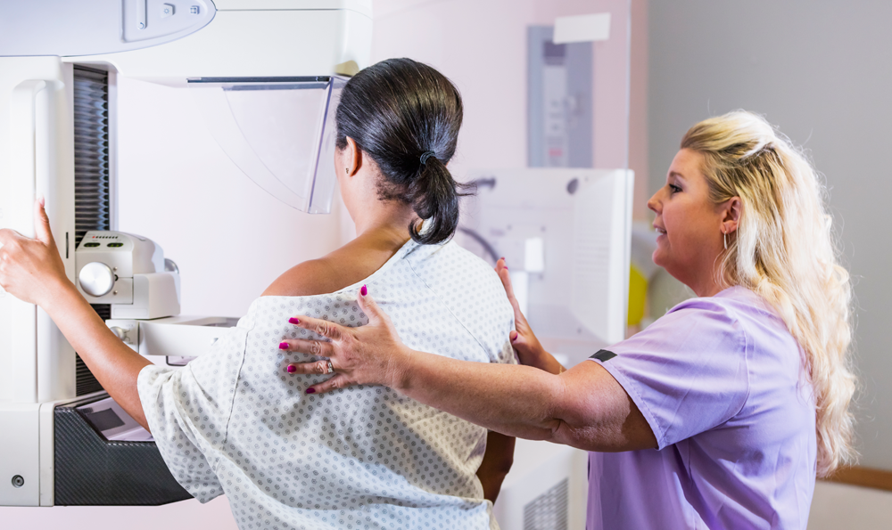 Woman receives mammogram.